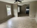Open living area with tile floors, ceiling fans, and connecting rooms for modern living at 7806 N Orleans Ave, Tampa, FL 33604