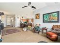 Open-concept living room showcasing a mix of carpet and wood flooring, a ceiling fan, and natural light at 8217 Canterbury Lake Blvd, Tampa, FL 33619