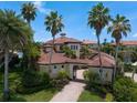 An aerial view of a Mediterranean-style home showcasing its red tile roof and manicured landscaping at 841 Ponce De Leon Dr, St Petersburg, FL 33715