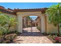 Close up of gated entrance to home, featuring colorful floral landscaping at 841 Ponce De Leon Dr, St Petersburg, FL 33715