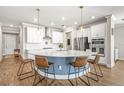 Gourmet kitchen with stainless steel appliances, a large center island and modern pendant lighting at 8460 Capstone Ranch Dr, New Port Richey, FL 34655