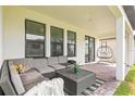 Cozy outdoor patio features ample seating and an outdoor swing perfect for relaxing at 8460 Capstone Ranch Dr, New Port Richey, FL 34655