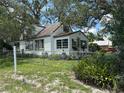White home featuring a fenced yard with beautiful vegetation at 8502 N Branch Ave, Tampa, FL 33604