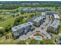 Overhead view of the condos overlooking a pond with fountain, golf course, and community pool at 960 Starkey Rd # 9104, Largo, FL 33771