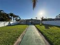 Spacious backyard with lush green grass, offering a private outdoor retreat at 6034 Bayou Grande Ne Blvd, St Petersburg, FL 33703