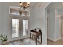 Bright foyer with a decorative chandelier, large front door, and a glimpse of the staircase at 10515 Canary Isle Dr, Tampa, FL 33647