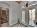 Spacious foyer with a decorative rug, large front door, stairs, and natural light at 10515 Canary Isle Dr, Tampa, FL 33647