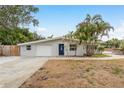 Charming single-story home with a well-manicured lawn, mature trees, and a cozy entrance at 12 Bayou Ln, Palm Harbor, FL 34683