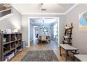 Open-concept living area with gray walls and tile floors transitions to formal dining room at 12208 Mcmullen Loop, Riverview, FL 33569