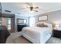 Spacious main bedroom features a ceiling fan, a king bed, and an ensuite bathroom at 12208 Mcmullen Loop, Riverview, FL 33569