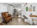 Inviting entryway showcasing wood-look tile floors and seamless access to the updated kitchen at 1242 74Th N St, St Petersburg, FL 33710