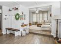 Open-concept living room with neutral paint, wood-look floors, and a cozy sitting area at 1242 74Th N St, St Petersburg, FL 33710
