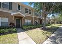 Exterior view showcasing the townhouse's entrance, landscaping, and inviting pathway at 12437 Foxmoor Peak Dr, Riverview, FL 33579