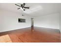The cozy living room features hardwood floors and a ceiling fan for added comfort at 13612 S Village Dr # 5201, Tampa, FL 33618