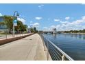 Inviting Riverwalk scene showcases a paved path alongside a waterway and a blue sky with clouds at 1501 Doyle Carlton Dr # 303, Tampa, FL 33602