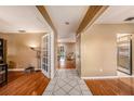 Inviting foyer with tile flooring leading into a spacious living area with hardwood floors at 15820 Sapwood St, Tampa, FL 33624