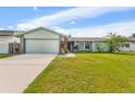 Charming single-story home featuring a well-manicured lawn and attached garage at 15917 Crying Wind Dr, Tampa, FL 33624