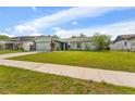 A single-story home showcases a well-maintained front lawn and a spacious driveway at 15917 Crying Wind Dr, Tampa, FL 33624