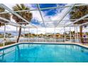 Beautiful screened-in pool overlooking the canal, with palm trees adding to the serene atmosphere at 2096 Massachusetts Ne Ave, St Petersburg, FL 33703