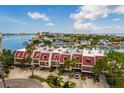 Aerial view of a townhouse complex with red roofs, waterfront access, and stunning neighborhood views at 222 Skiff Pt, Clearwater, FL 33767
