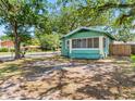 Charming cottage-style home with a screened-in porch and a spacious yard in a residential neighborhood at 302 W Curtis St, Tampa, FL 33603