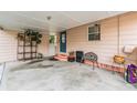 Carport with concrete flooring and light pink painted siding at 3035 Hillview St, Sarasota, FL 34239