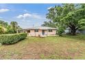 Charming single-story home with a manicured lawn and mature trees at 3035 Hillview St, Sarasota, FL 34239