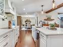 Open-concept kitchen with wood floors, island sink, and views of the adjacent dining area at 3724 Fawn Grove Ct, Land O Lakes, FL 34639