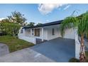 Charming single-story home with a well-manicured lawn and covered parking at 3947 Overlook Ne Dr, St Petersburg, FL 33703