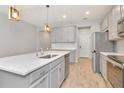 Stylish kitchen with stainless steel appliances, quartz counters, and a central island at 4262 Cloud Hopper Way, Lutz, FL 33559