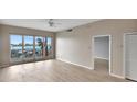 Inviting living room with access to a waterfront balcony with views and neutral color palette at 530 S Gulfview Blvd # 203, Clearwater Beach, FL 33767