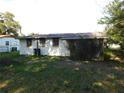 A single story home with an air conditioning unit sits in the backyard at 5707 S 79Th St, Tampa, FL 33619