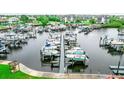 Aerial view of the boats docked in the marina along the shore with buildings in the background at 5712 Biscayne Ct # 201, New Port Richey, FL 34652