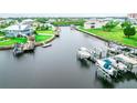 Aerial view of boats docked on backyard canals behind waterfront homes with green lawns at 5712 Biscayne Ct # 201, New Port Richey, FL 34652