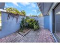 Private courtyard with brick pavers and lush tropical plants at 605 Citrus Ct, Largo, FL 33770