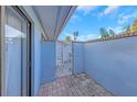 Enclosed courtyard featuring brick pavers and a decorative white metal gate at 605 Citrus Ct, Largo, FL 33770