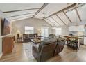 Spacious living room with vaulted ceilings, wooden beams, and contemporary furnishings at 611 Shore E Dr, Oldsmar, FL 34677