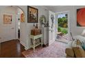 Bright and inviting foyer with hardwood floors, decorative art, and a view of the front yard at 6202 7Th S Ave, Gulfport, FL 33707