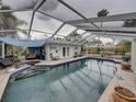Inviting screened-in pool area with ample seating, a covered lounge, and stylish patio furniture at 6202 7Th S Ave, Gulfport, FL 33707