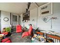 Cozy front porch, furnished with chairs, decorated with personal items and house number displayed on the wall at 6807 N Himes Ave, Tampa, FL 33614