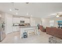 Open-concept kitchen featuring an island with seating and modern appliances at 6961 King Creek Dr, Sun City Center, FL 33573