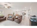 Bright living room featuring tile floors, ceiling fans, and an open floor plan at 6961 King Creek Dr, Sun City Center, FL 33573