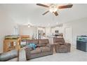 Bright living room featuring tile floors, ceiling fans, and an open floor plan at 6961 King Creek Dr, Sun City Center, FL 33573