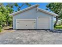 A detached garage with a two-car garage door and a single car garage door at 7815 16Th Nw Ave, Bradenton, FL 34209