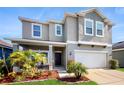 Charming two-story home with a two-car garage, beautiful front yard, and well-maintained landscaping at 8111 Brickleton Woods Ave, Gibsonton, FL 33534