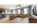 Comfortable living room featuring a large sectional sofa, modern floors, and plenty of natural light at 8111 Brickleton Woods Ave, Gibsonton, FL 33534