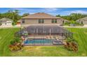 Relaxing screened-in pool area featuring comfortable lounge chairs, lush landscaping, and a spa at 9136 Warm Springs Cir, Parrish, FL 34219