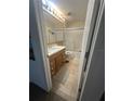 Bathroom featuring a vanity with storage, a framed glass shower/tub, and tile floors at 10402 Ashley Oaks Drive, Riverview, FL 33578