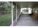 Covered screened patio with chairs and peaceful backyard views at 10402 Ashley Oaks Drive, Riverview, FL 33578