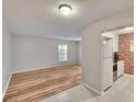 Bright living room with light wood floors, a large window, and access to the kitchen at 125 Picardy Villa Cir # 100, Brandon, FL 33510